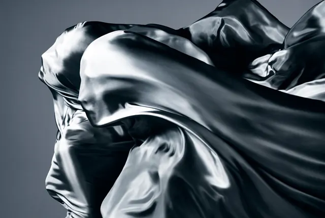 Dramatic silk fabric sculpture in black and white, photographic, minimal, dark