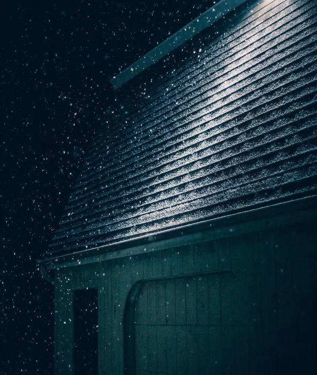 Snowy wooden cabin at night, monochrome, dark-mode, dark