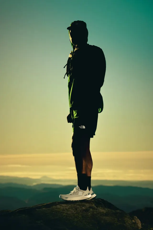 Hiker Silhouette on Mountain at Sunrise, photographic, minimal, dark