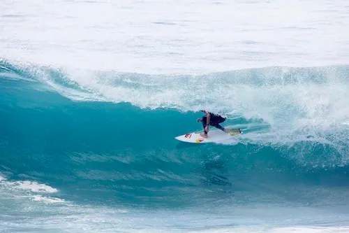Surfer on a Blue Wave