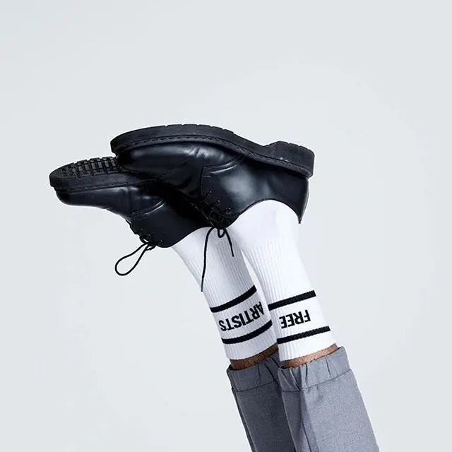 Typographic socks with bold text branding, minimal, graphic, dark