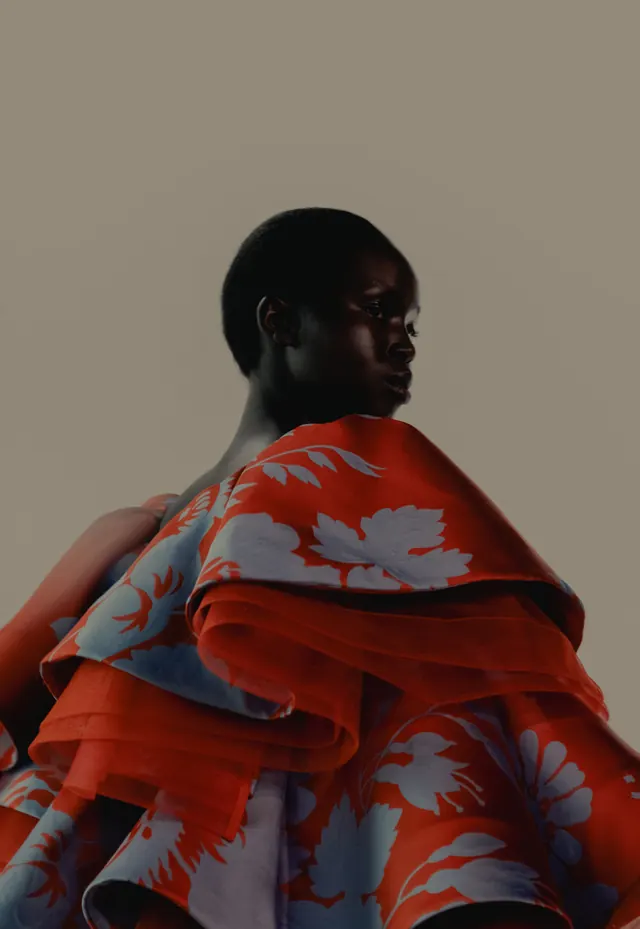 Portrait figure draped in red and blue floral patterned fabric, photographic, organic, vibrant