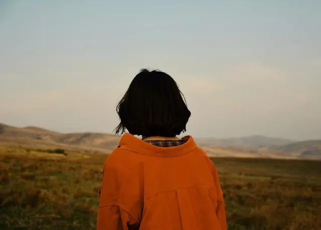 Person in Orange Hoodie in Field