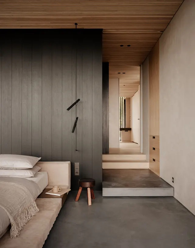 Minimalist luxury bedroom with wood and concrete, minimal, corporate-clean, dark