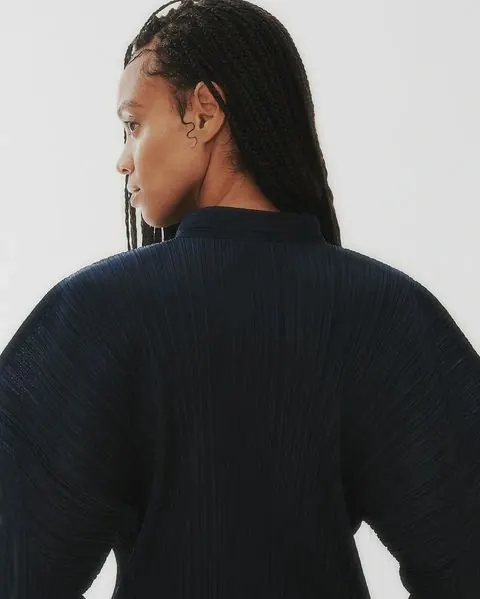 Portrait of a person in a textured knit sweater