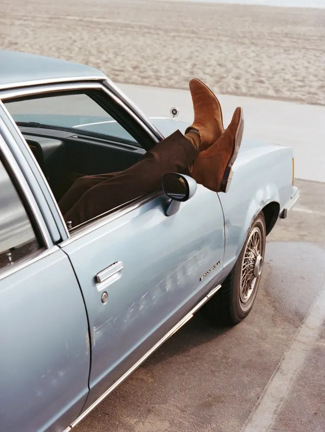 Person leaning on vintage car