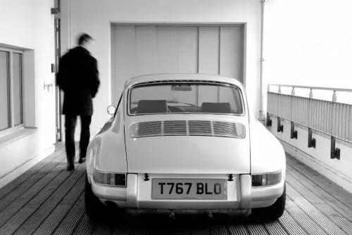 Man and Vintage Car in Industrial Space