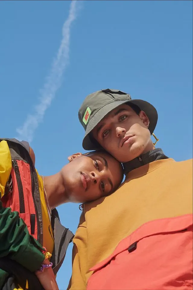 Low-angle Nike streetwear couple portrait, photographic, playful, vibrant