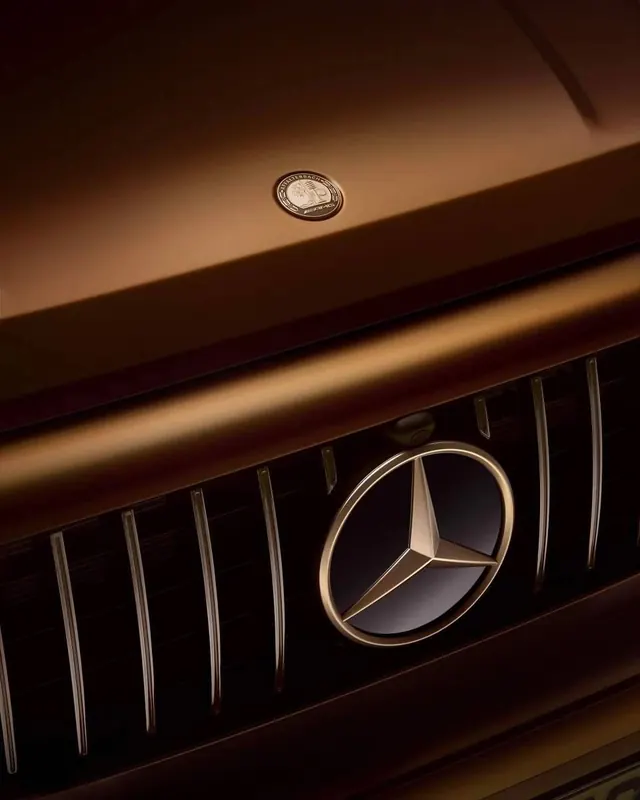 Bronze AMG grille close-up, minimal, luxury, warm