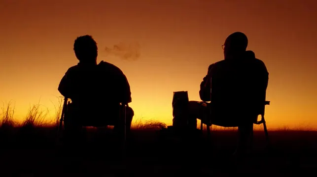 Silhouetted figures at orange sunset, photographic, cinematic, warm