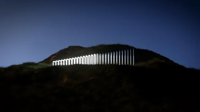 Hillside light portal installation, minimal, photographic, dark