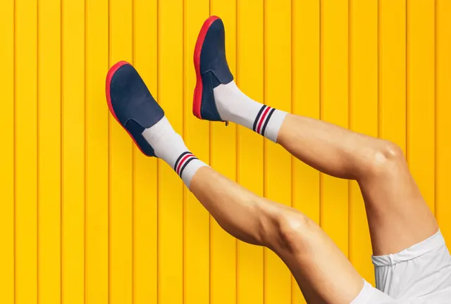 Colorful sneaker against yellow background, photographic, minimalist, vibrant