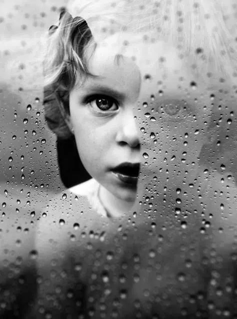 Child behind rain-covered window portrait, photographic, monochrome, monochrome