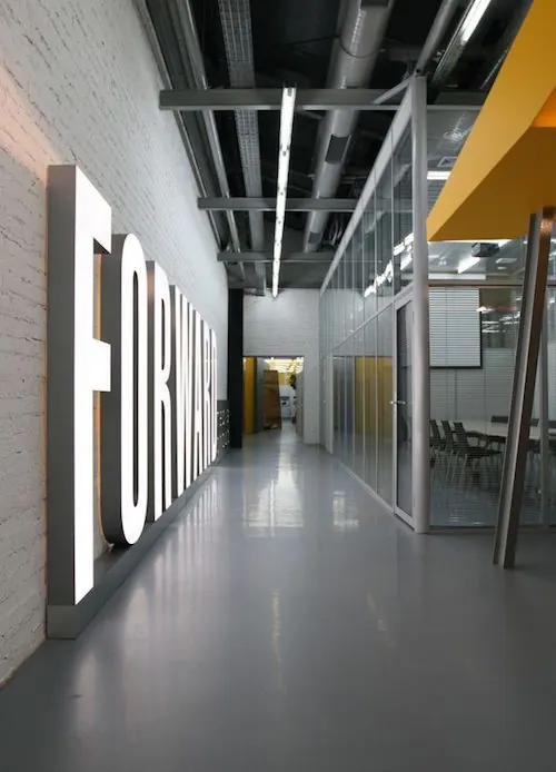 FORWARD illuminated office corridor sign, corporate-clean, minimal, light
