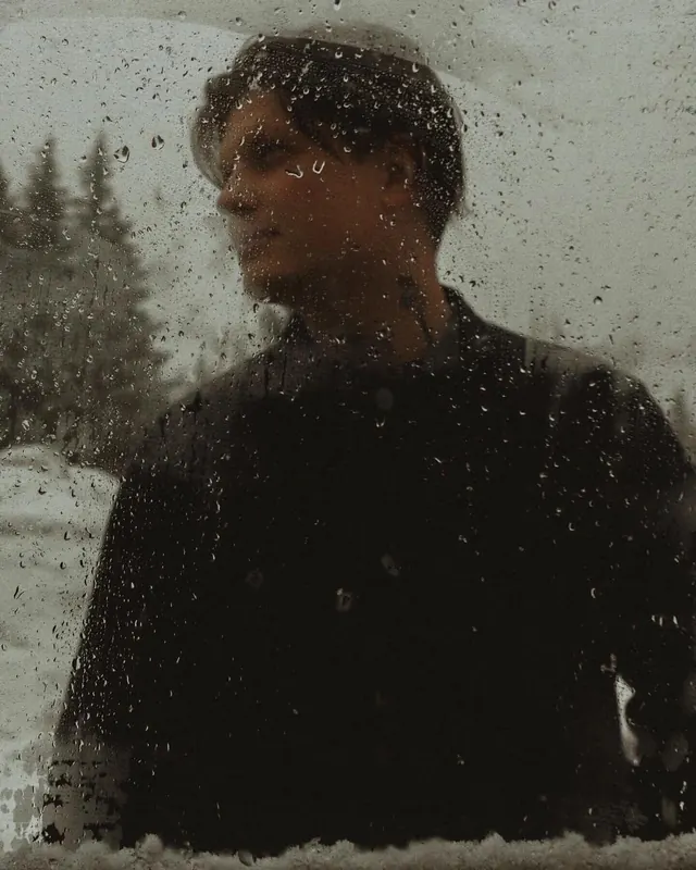 Rainy window portrait in snow, photographic, dark-mode, dark