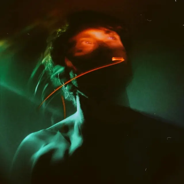 Experimental green-orange light portrait, photographic, abstract, dark