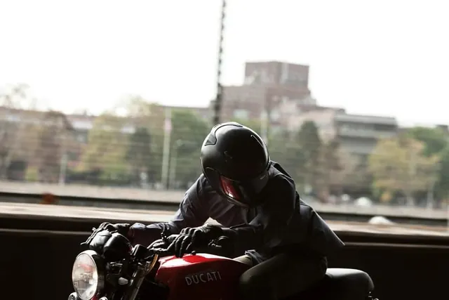 Motorcyclist with ducati, photographic, dark-mode, dark