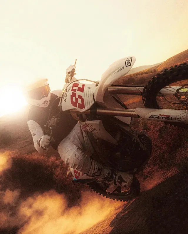 Motocross berm turn at golden hour, photographic, technical, warm