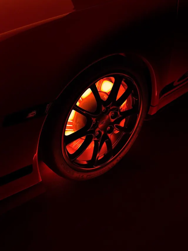 Glowing Porsche brake rotor portrait, photographic, dark-mode, dark