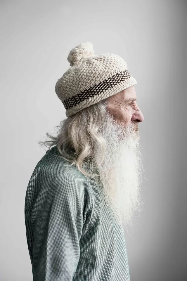 Profile portrait with long white beard, photographic, minimal, muted