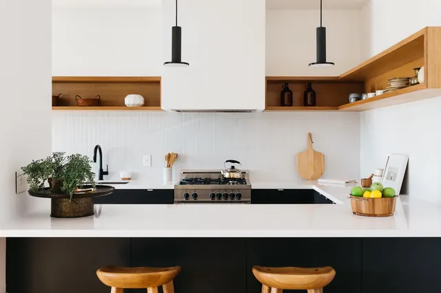Black-and-white kitchen with wood shelves, minimal, corporate-clean, light