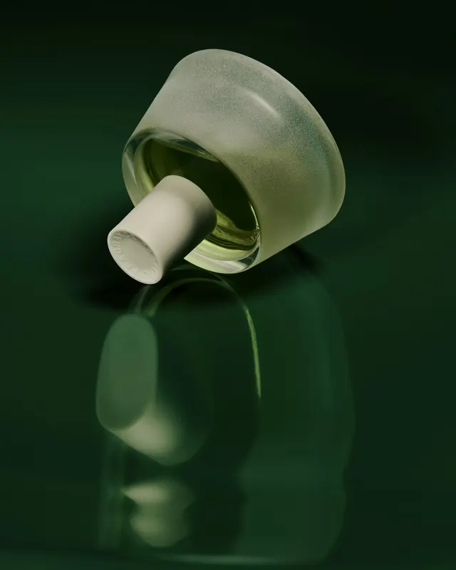 Green fragrance bottle on glossy surface, minimal, luxury, dark
