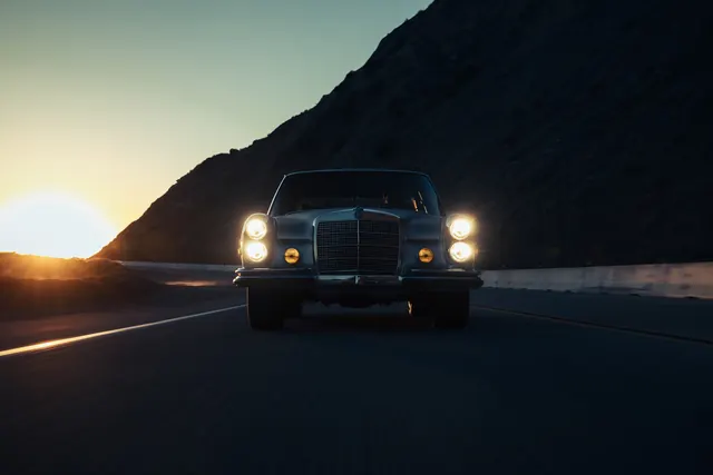 SUV on Mountain Road at Sunset, photographic, minimal, dark