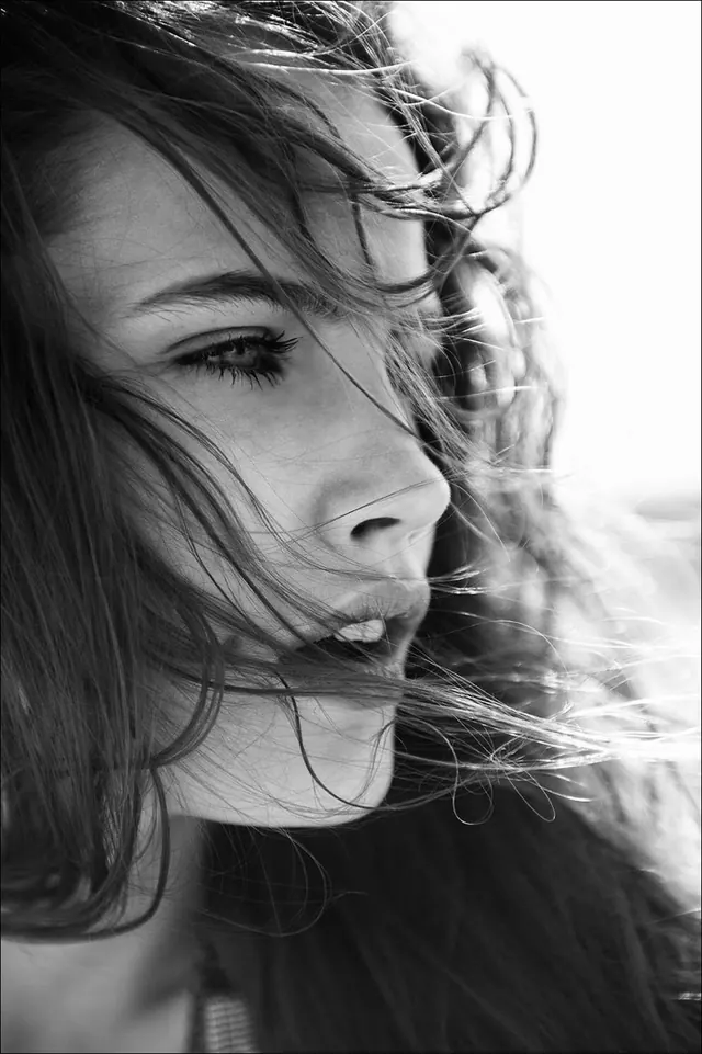 Close-up Portrait of a Woman with Wind-blown Hair, monochrome, photographic, monochrome