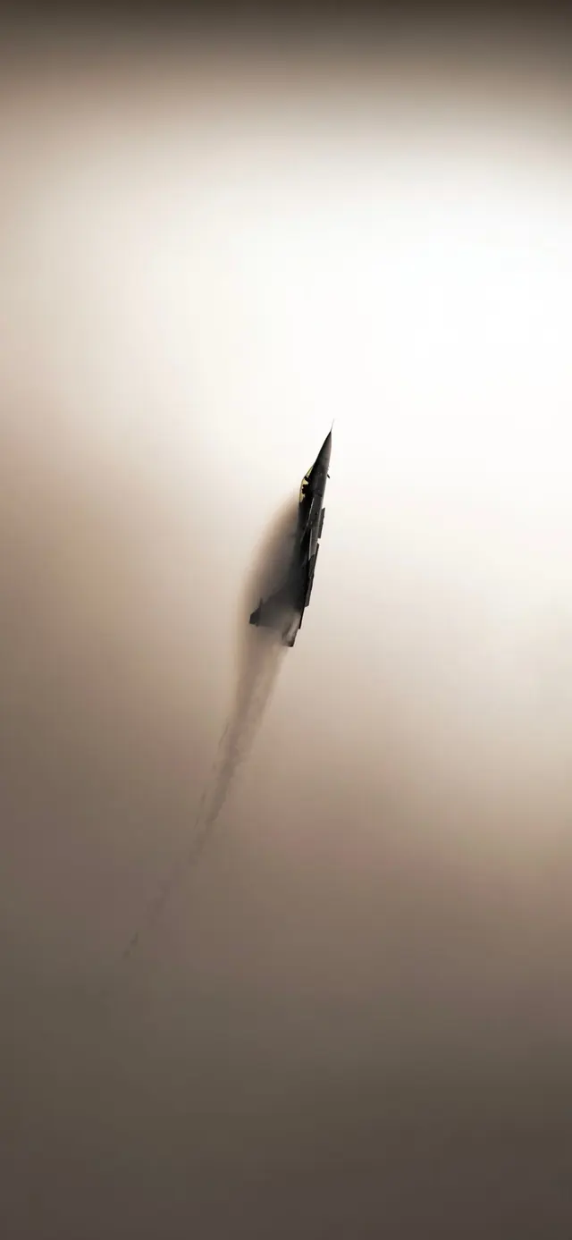 Fighter jet in atmospheric haze, photographic, minimal, muted