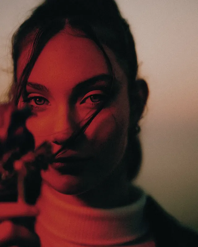 Red-lit cinematic portrait, photographic, editorial, dark