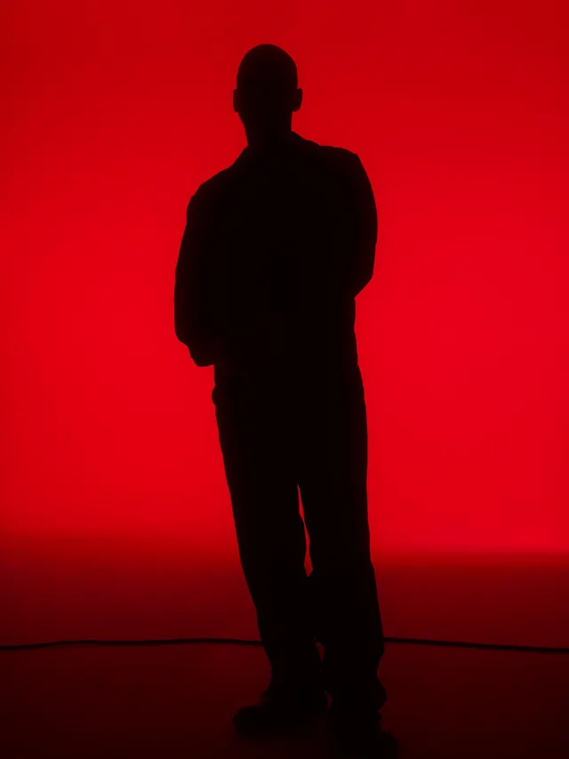 Red cyclorama silhouette figure, minimal, photographic, vibrant