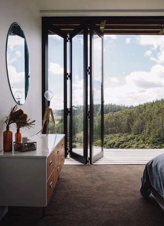 Forest-view bedroom with bifold doors, minimal, organic, light