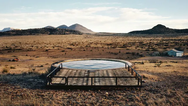 Desert pool deck in Marfa landscape, photographic, minimal, warm