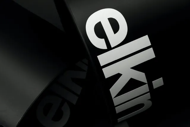 Elkin wordmark on curved black packaging, minimal, luxury, dark