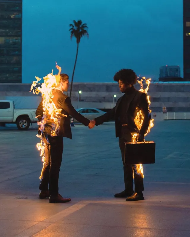 Burning handshake parking lot tableau, photographic, cinematic, dark