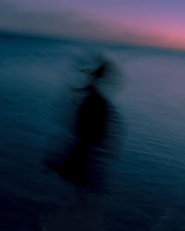 Blurred figure by twilight sea, abstract, photographic, dark