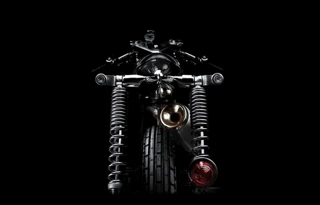 Custom motorcycle rear low-angle portrait, photographic, minimal, dark