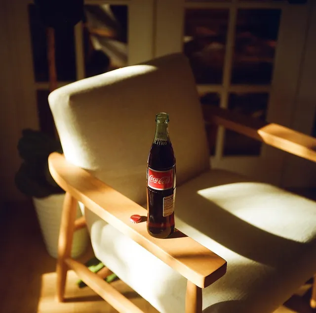 Beer Bottle on Armchair, photographic, organic, warm