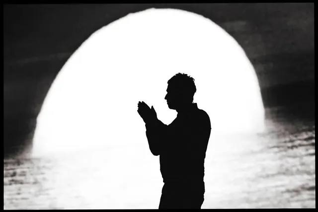 Silhouette against a glowing orb, minimal, monochrome, monochrome