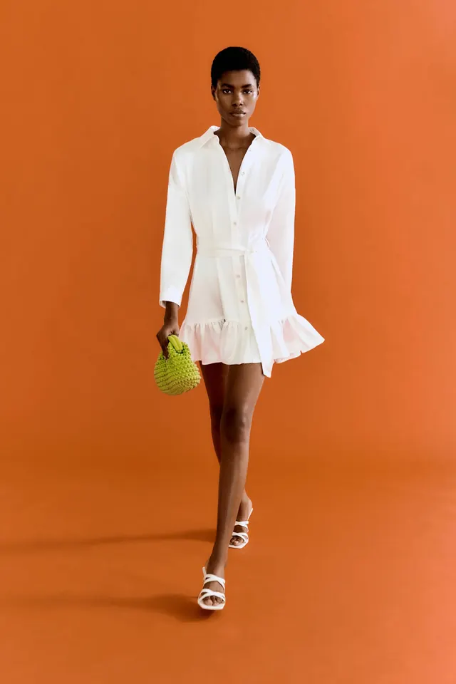 White shirt-dress on orange set, editorial, photographic, vibrant