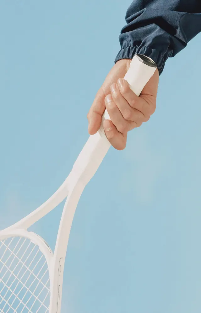 White tennis racket on pastel blue, minimal, photographic, light
