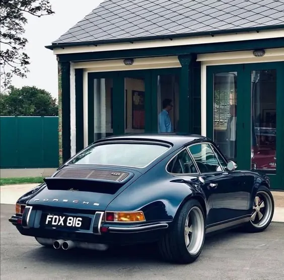Classic blue Porsche rear three-quarter, photographic, minimal, cool