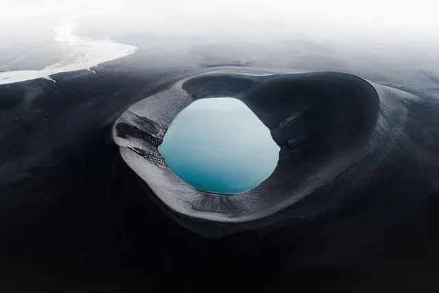 Aerial volcanic crater lake, minimal, photographic, dark