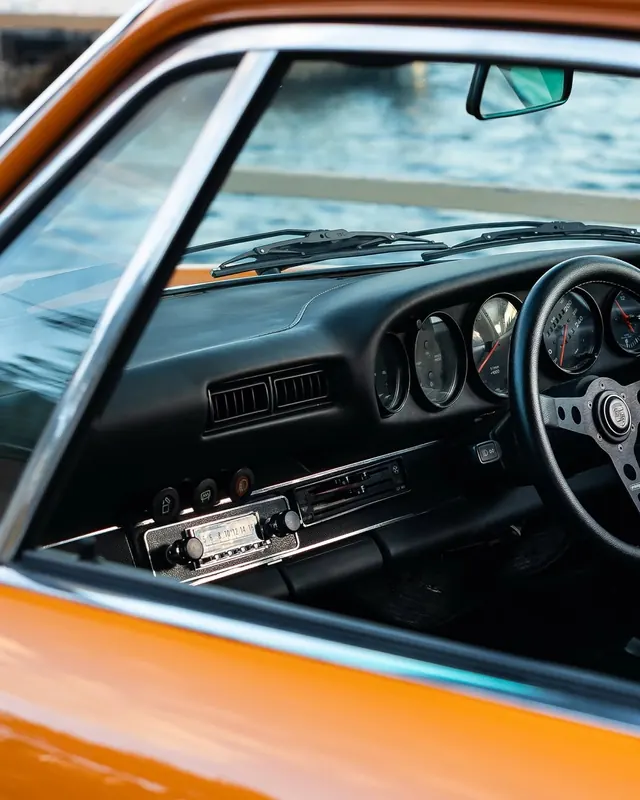 Vintage Porsche interior detail, photographic, retro, warm