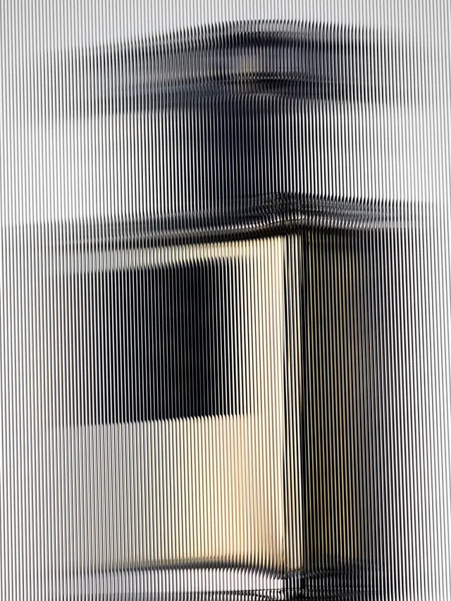 Perfume bottle through fluted glass, minimal, abstract, monochrome