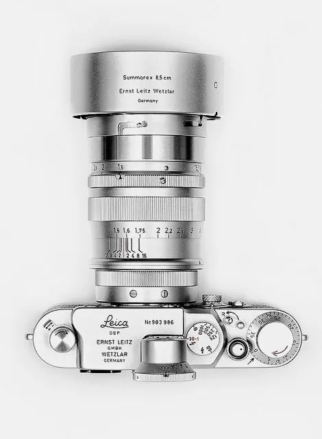 Vintage chrome camera on light background, minimal, photographic, light