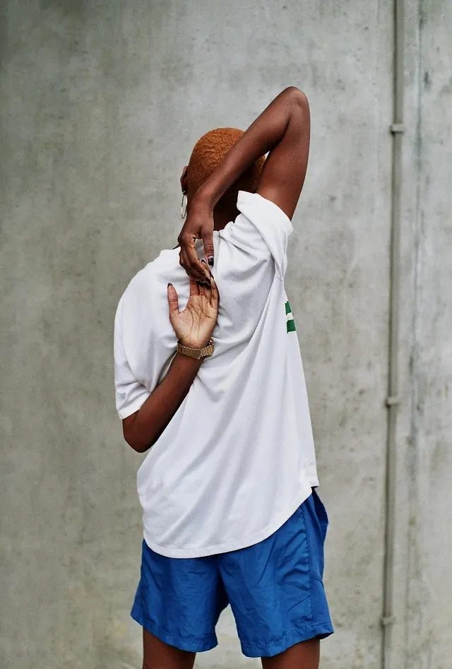 Man in White T-Shirt and Blue Shorts