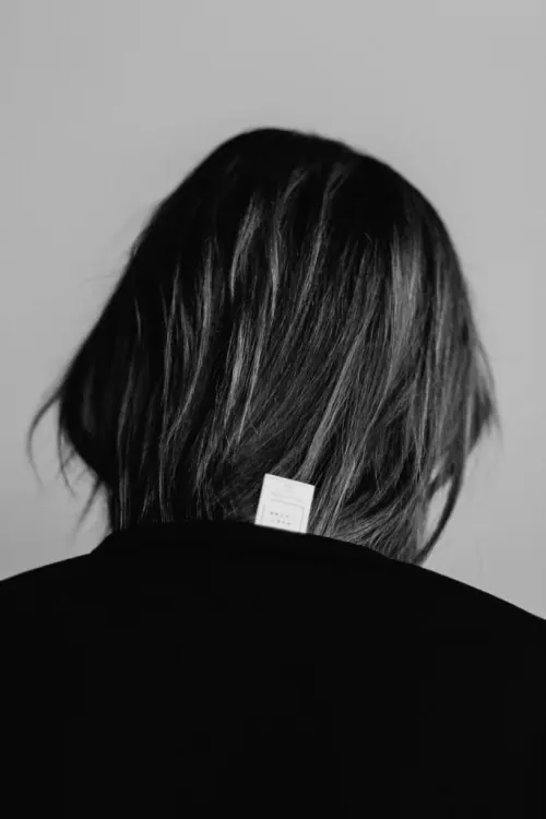 Portrait of a person with a white tag