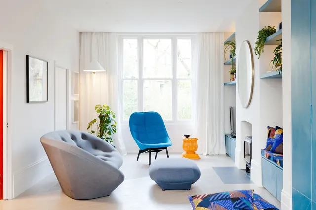 Bright living room with blue tufted chair, minimal, light-mode, light