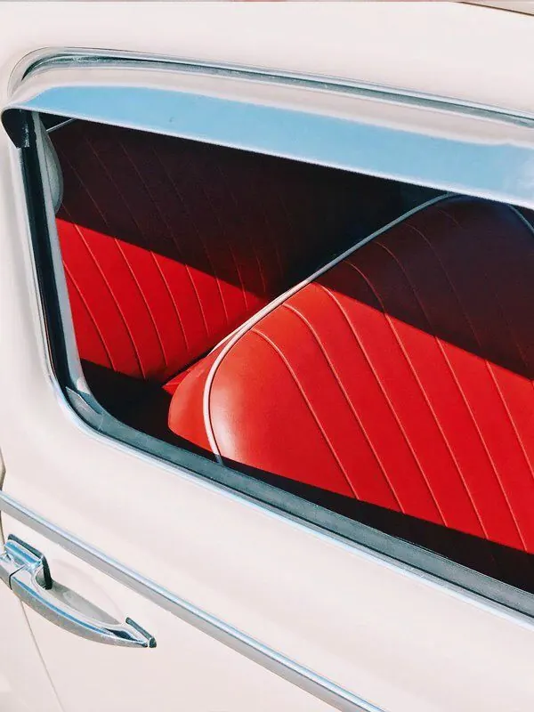 Vintage car interior with red leather seats, retro, dark